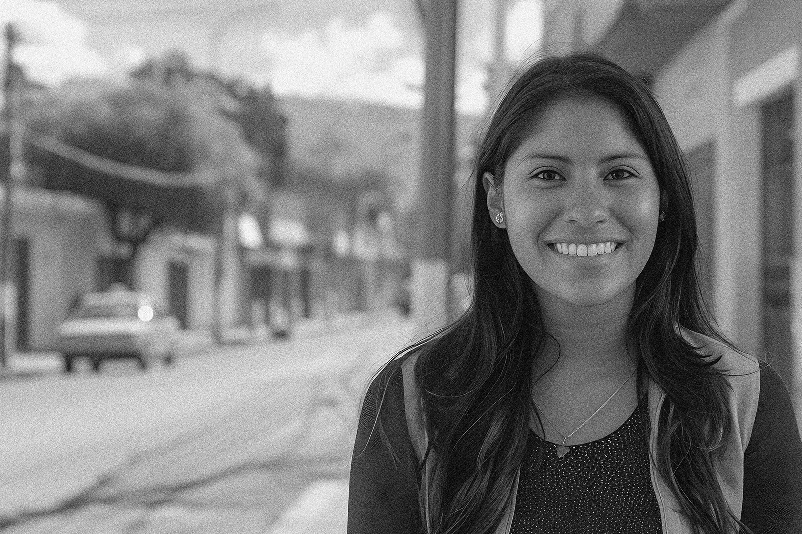 Portrait of a woman smiling on a street